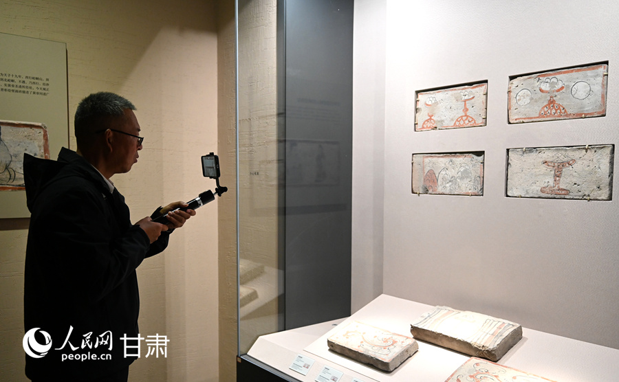 何以中国·壁画里的中国丨一砖一景见风华 探寻魏晋壁画砖里的千年烟火气 游客在高台县博物馆参观。人民网 席娟娟摄